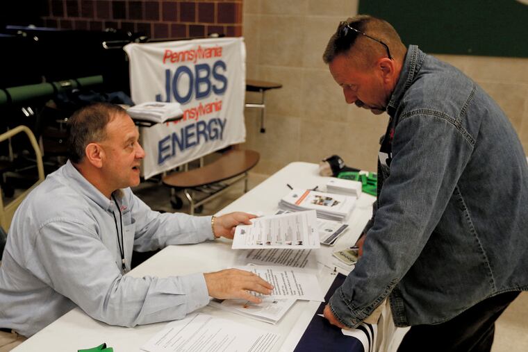 A recruiter in the shale gas industry, left, speaks with an attendee of a job fair in Cheswick, Pa. Hiring in the United States jumped in February 2020 as employers added a robust 273,000 jobs, evidence that the economy was in strong shape before the coronavirus began to sweep through the nation.