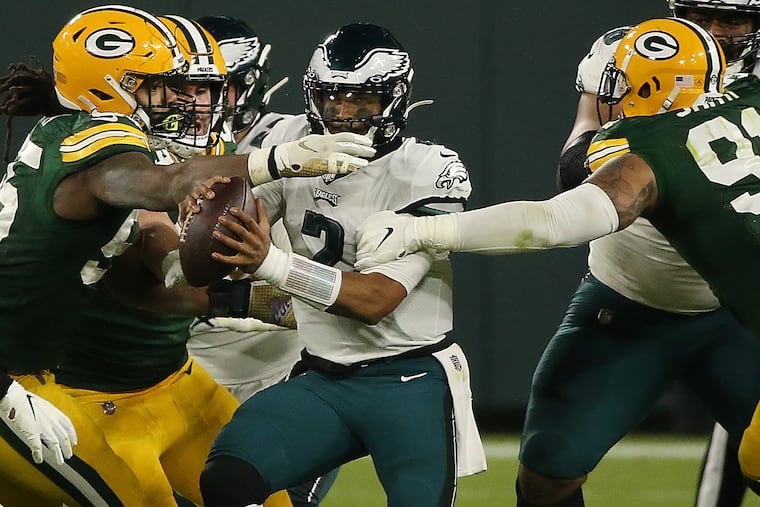 Quarterback Jalen Hurts felt the pressure from Za'Darius Smith (right) and others in the Eagles' loss to the Packers at Lambeau Field on Dec. 6, 2020.