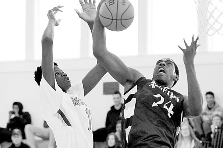 Westtown's Mohamed Bamba, left, fights for a rebound against Phelps School's Mike Watkins, right in the first half of play in the PAISSA Tournament Championship game Saturday, Feb. 21, 2015 in Malvern, Pa. (Bradley C Bower/Staff Photographer)