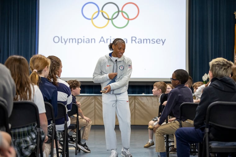 Ariana Ramsey shows her Olympic bronze medal to students her bronze medal at Norwood-Fontbonne Academy on Friday.
