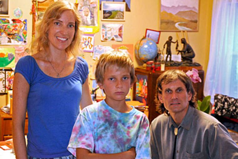Mark and Gosla Still with son Zbyszek, 9. Mark Still organized a meeting of parents seeking the exit of school founder Dorothy June Brown and others facing federal charges. (Tom Gralish/Staff)