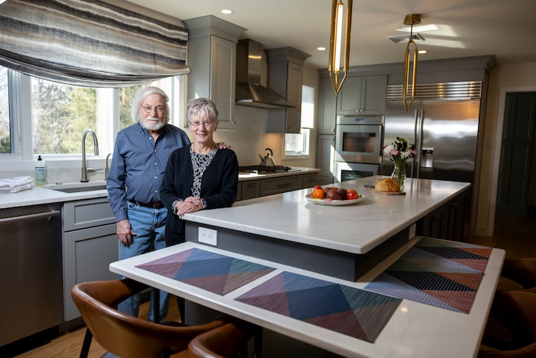 Jan Volin and Philip Goldstein stand in their renovated kitchen in Maple Glen. New features include an island with countertops at different heights for working and sitting, with wheelchair height taken into account.