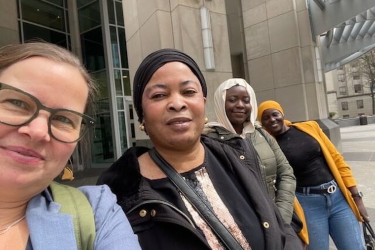 CLS Senior Staff Attorney Nadia Hewka (left) takes a selfie with Natural Hair Braiding salon owner Maimouna Thiam (black coat) and her friends. Last week, Commonwealth Court ruled the state's braiding regulations violated her PA constitutional rights.