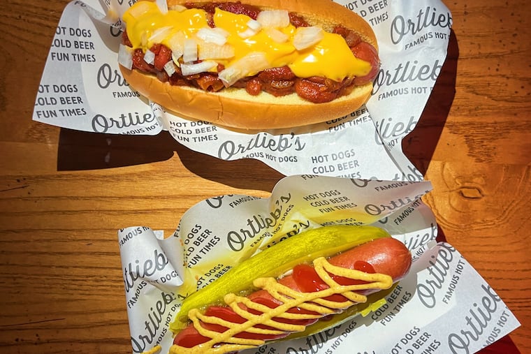 The chili cheese dog dog (top) and pickle dog (bottom) at Ortlieb's in Northern Liberties are offered in both meat and vegan versions.