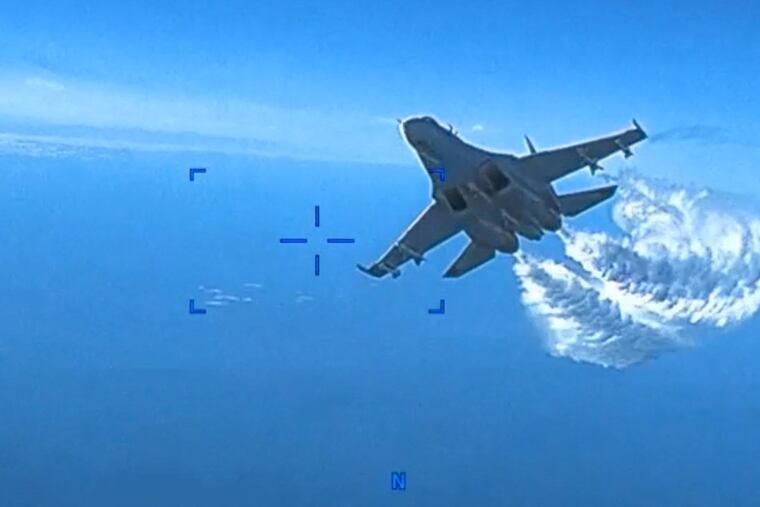 The U.S. military's European Command has released footage of the Tuesday encounter between a U.S. surveillance drone and a Russian fighter jet as it played out over the Black Sea. The newly declassified video depicts critical moments in the mid-air encounter, which the Pentagon said lasted about 40 minutes. The video shows the camera of the MQ-9 Reaper drone pointed backward toward its tail, and the drone's propeller, which is mounted on the rear, spinning. Then, a Russian Sukhoi SU-27 fighter jet is shown approaching. As it draws closer, the Russian fighter dumps fuel as it intercepts the U.S. drone. Russia has denied that a collision occurred.