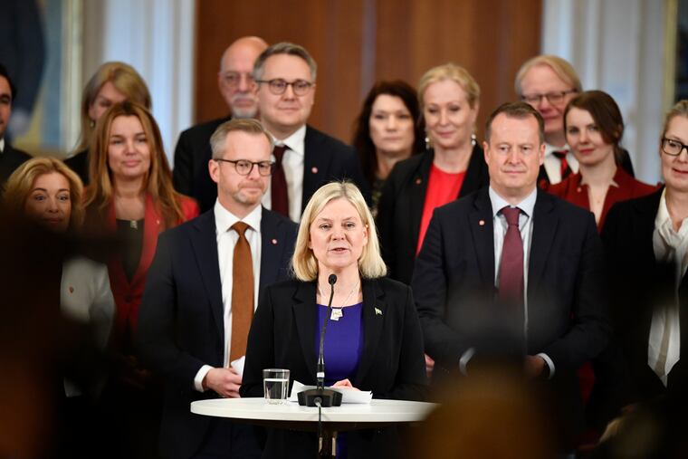 Swedish Prime Minister Magdalena Andersson (center), with her new cabinet members behind her, speaks during a press conference in Stockholm on Tuesday.