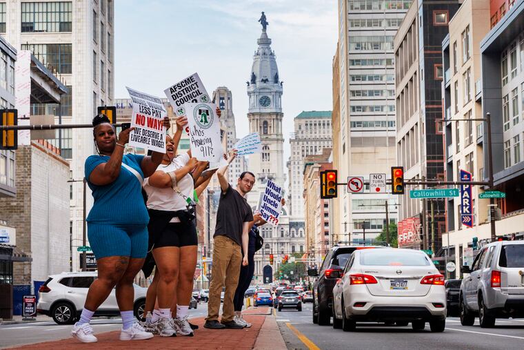 AFSCME District Council 33 workers strike outside police headquarters on Broad Street Tuesday morning.