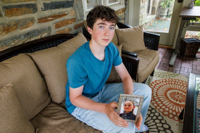 Matt Jacoby holds a photo of his ice dance partner, Alydia Livingston, at his home in Bala Cynwyd.