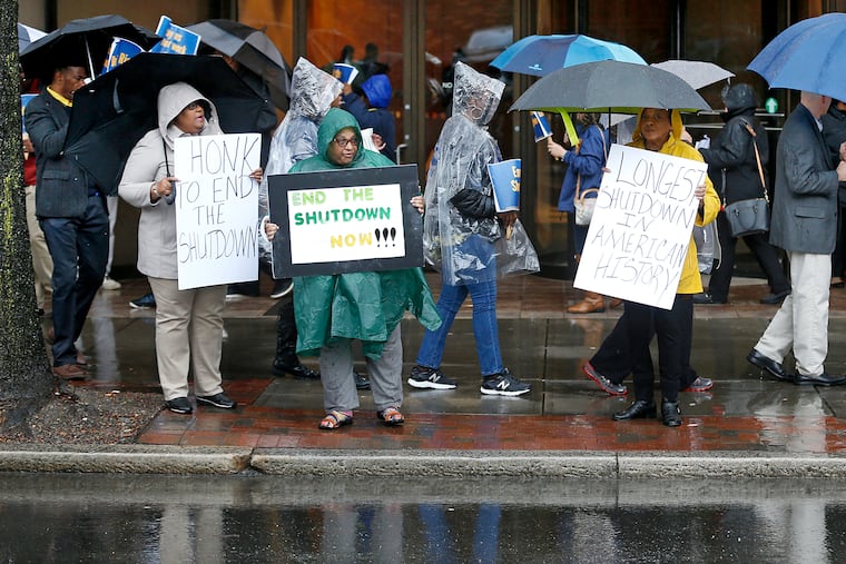 People demonstrate in Richmond, Va., to support The U.S. Department of Housing and Urban Development and Bureau of Prisons employees who are affected by the partial government shutdown on Thursday.