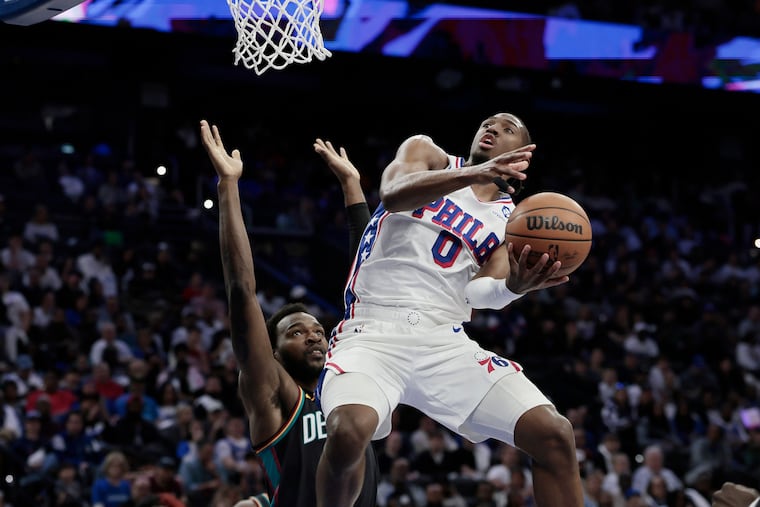 Pistons Paul Reed defends against the Sixers Tyrese Maxey in the first half of Saturday's game at Xfinity Mobile Arena.