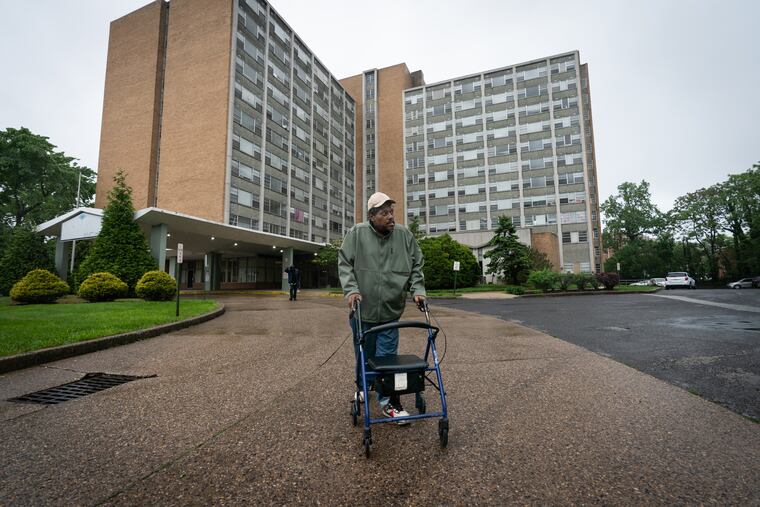 Timothy Sharpe, one of many senior citizen residents of Brith Sholom House, a large apartment building that is in disrepair, shown here walking to the bus stop.