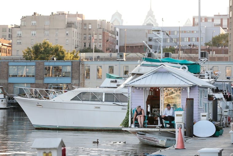 Jeannie Richter Conn and husband Peter Conn enjoy the porch of their houseboat, which is docked on the Delaware River, adjacent to the Race Street Pier. The ducklings were born in their basil pot. The Conns have named their mother Esther Violet.