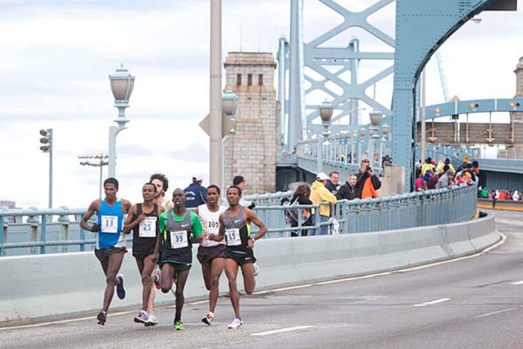 A pack of runners cross the Ben Franklin Bridge as part of Run the Bridge 10K, a fund-raiser for the Larc School, a Bellmawr nonprofit for children with moderate to severe disabilities. (Ed Hille/Staff)