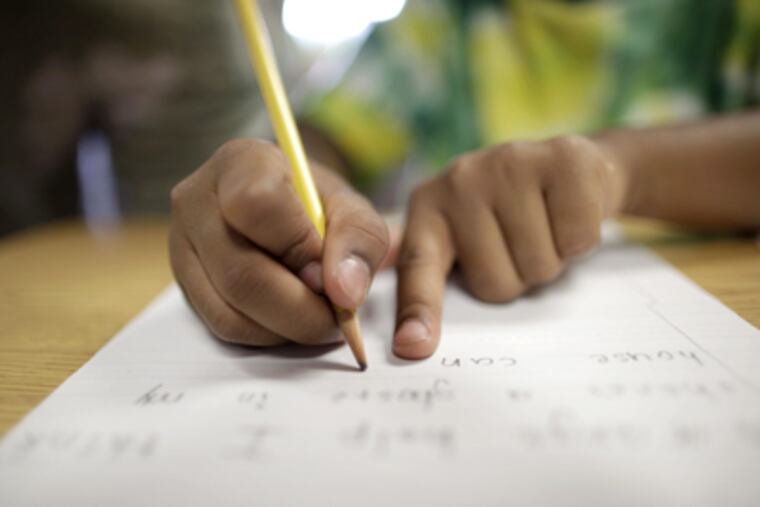 Sanana Nicholson, 7, learns proper penmanship at Plymouth Meeting Friends School. (David Swanson / Staff Photographer)