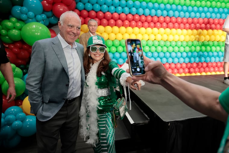 Eagles owner Jeffrey Lurie and “Halftime Holly” Teti of Newtown Square pose for a photo during the Eagles Autism Challenge kickoff party in May.