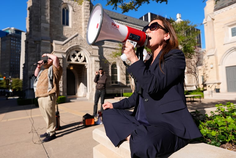 A supporter, who did not wish to be named, uses a megaphone outside the Eldon B. Mahon U.S. Courthouse in March during a trial for nine people connected to a 2025 shooting outside an ICE detention facility, in Fort Worth, Texas.