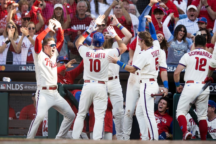 J.T. Realmuto is congratulated by the dugout after an inside-the-park home run in the third inning.