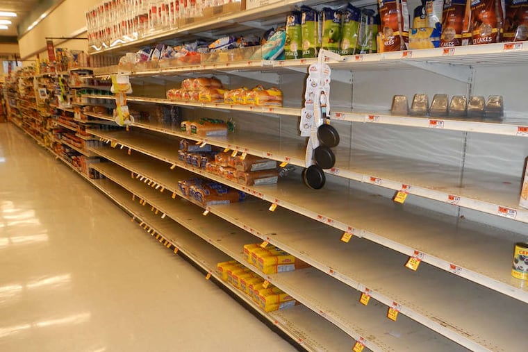 An Acme store near Kings Highway in Haddonfield has nearly bare bread shelves. Grocery stores tried to stock up on many such goods but not on perishables.