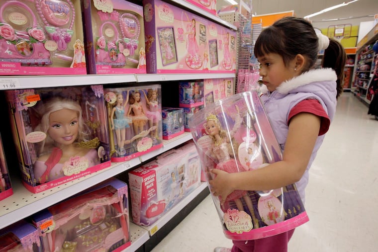 In this Jan. 29, 2007, file photo Yvette Ibarra holds a Dancing Princess Barbie doll while shopping at a toy store in Monrovia, Calif. Gov.