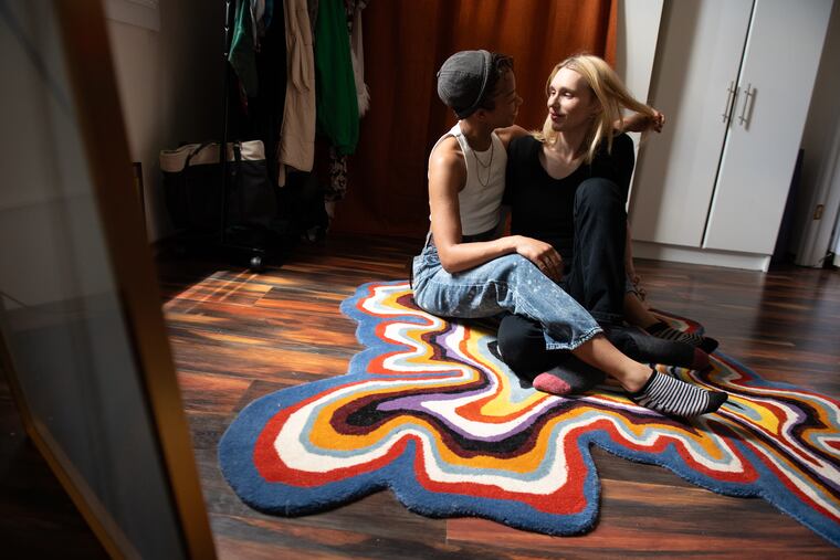 Jet (left) moves hair out of the author’s face inside the couple’s home in Philadelphia this week.
