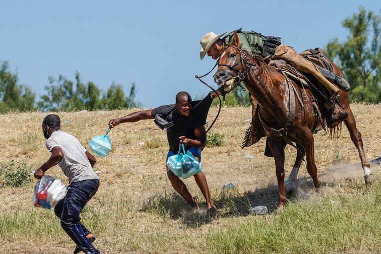 A U.S. Border Patrol agent on horseback tries to stop a Haitian migrant from entering an encampment on the banks of the Rio Grande near the Acuna Del Rio International Bridge in Del Rio, Texas, on Sept. 19.