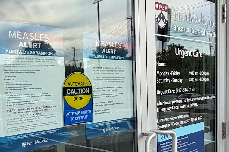 An alert about measles is posted in the window of a medical clinic in Lancaster. State officials reported two deaths associated with measles in county residents earlier this week.