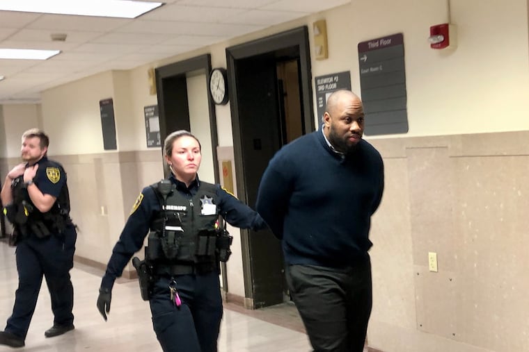 Blair Watts is escorted into a courtroom Friday during his trial on murder and related offenses in the Montgomery County Courthouse.