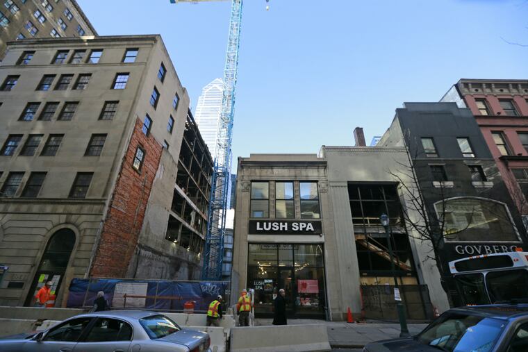 The building at left is the former bank, to be topped with a glassy overbuild. The vacant spot will be the site of “the spine.”