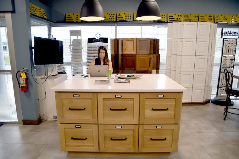 Andrea Mulkey, president and cofounder of ACO Denver Custom Cabinetry, works in her showroom in Denver. While her company doesn't sell foreign products or rely on imported components, she is concerned about the strains from a sudden surge in demand.