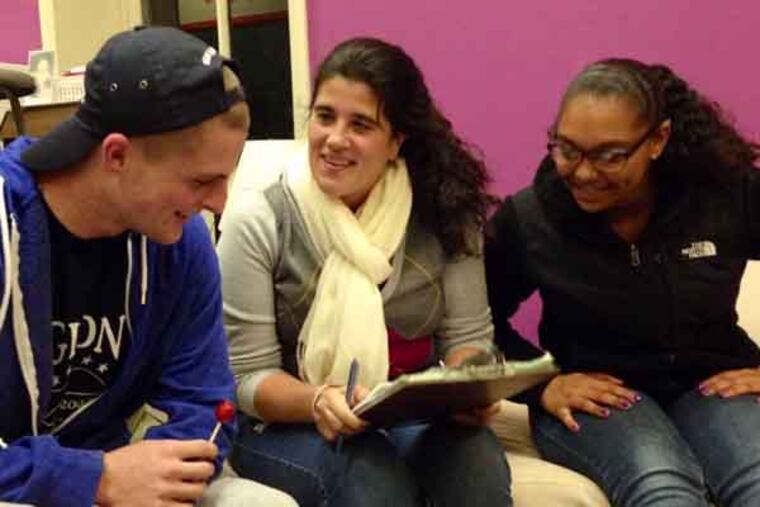 Teenagers Inc. director Arianna Neromiliotis, center, discusses details of the organization's Taste of Chestnut Hill fundraiser with teen emcees Brennan O'Donnell, left, and Chandler Dixon. (Morgan Zalot / Daily News Staff)