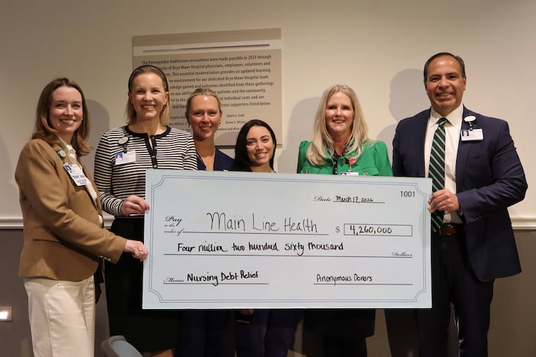 Executives and nurses at Main Line Health pose with a check representing more than $4 million in anonymous donations sent to the hospital system to help pay nurses' student loans in the last year. Left to right: Fiona Felton, vice president of patient services at Bryn Mawr Hospital; Cinda Johnson, executive director of development at Bryn Mawr; Reilly Fielder, nurse; Bianca Abate, nurse; Elizabeth Craig senior vice president and chief nursing officer at Main Line; and Ed Jimenez, Main Line's CEO and president.