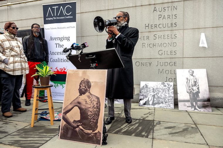 Attorney Michael Coard, leader of the Avenging the Ancestors Coalition, speaks at the President’s House site Monday, during the group's annual gathering for a Presidents’ Day observance. A federal judge ordered the Trump administration to restore the slavery exhibits that the National Park Service removed from the site last month.