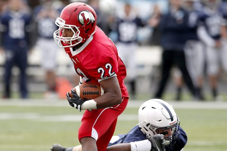 JoJo Kellum (left) of Lenape avoids Colin Wetterau of Shawnee as he runs for a lengthy gain in the 2nd quarter on Nov. 24, 2016.