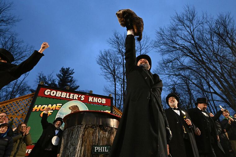Groundhog Club handler A.J. Dereume holds Punxsutawney Phil, who saw his shadow on Feb. 2, predicting an early spring. Human forecasters are suggesting that Phil could use more sleep.