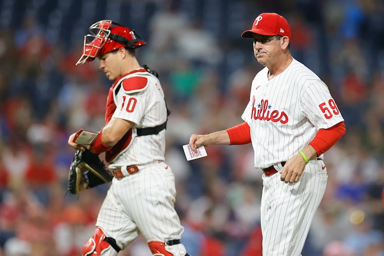 Phillies interim manager Rob Thomson and catcher J.T. Realmuto after a pitching change against the Washington Nationals on Saturday.