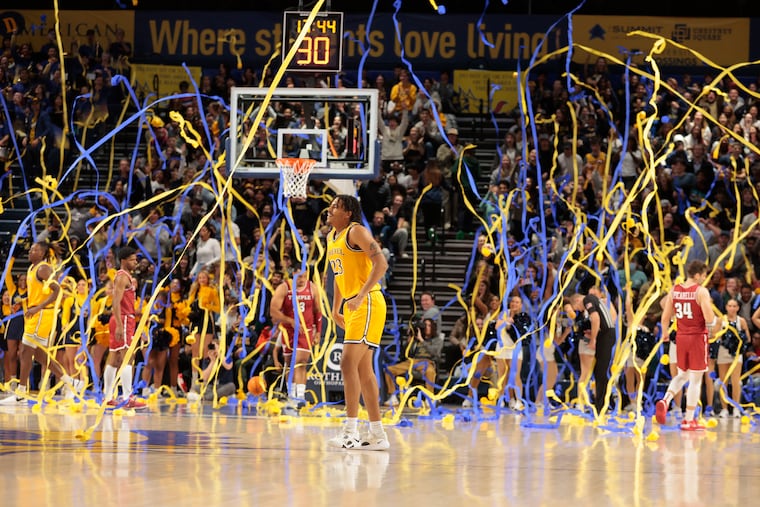 Drexel srudents shower the court with streamers after the first basket against Temple on Nov. 14, 2023.