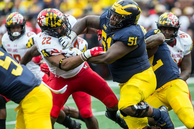 Michigan center Cesar Ruiz (51) blocking Maryland linebacker Isaiah Davis.