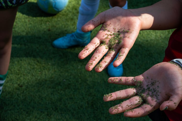 Artificial turf infill can cling to players' clothes and skin. MUST CREDIT: Maxine Wallace/The Washington Post