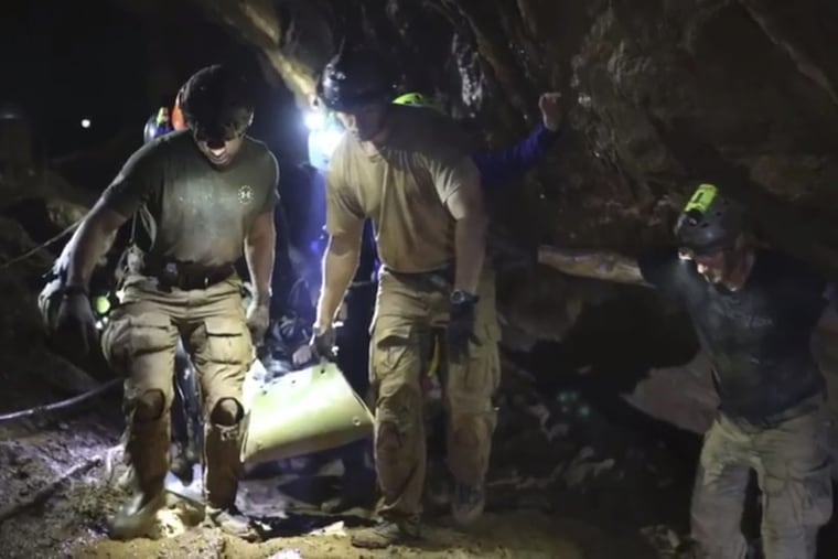 Thai Navy Seals rescue one of the 12 boys trapped inside the Tham Luang Nang Non cave in Mae Sai, Chiang Rai province, in northern Thailand.
