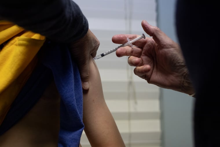 A child receives a dose of the Pfizer-BioNTech COVID-19 vaccine at a pediatric's office in West Bloomfield, Mich., on Nov. 4, 2021.
