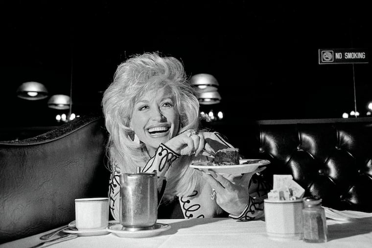 Dolly Parton savors a chocolate mousse cake. Parton, the country singer, songwriter, entertainer and entrepreneur whose rags-to-riches story, outsize persona and prodigious vision and talent placed her in a class by herself, died in Nashville on Tuesday, Aug. 25, 2026. She was 80.