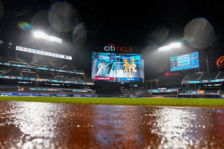 Rain falls during a rain delay of a game between the Mets and Marlins early Friday in New York.