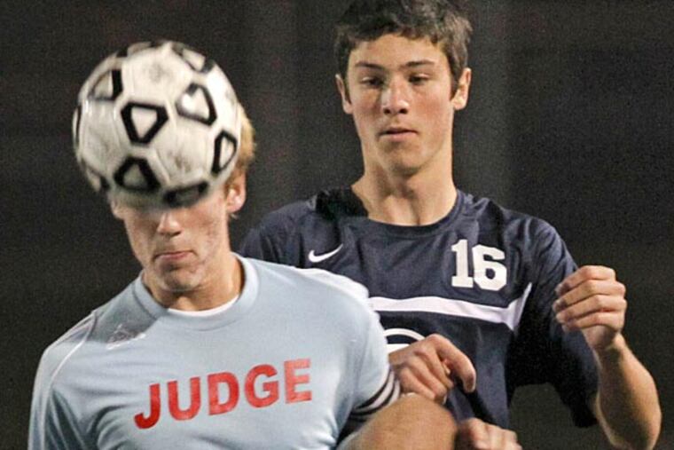 Father Judge's (15) Joey Hansen heads the ball away from West Chester
Rustin's (16) Chase Morgan during the first half. (David M Warren/Staff Photographer)