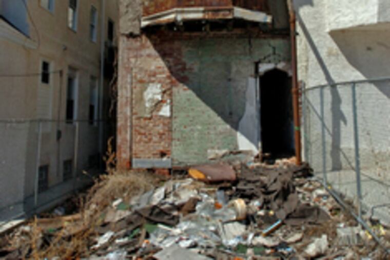 A decrepit Berry property at 1307 N. 15th St. stands out in a row of freshly renovated houses.