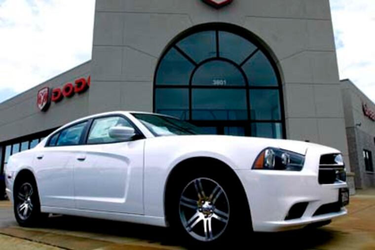 FILE- In this Sunday, June 24, 2012, file photo a new Dodge Challenger is for sale at an auto dealership in Springfield, Ill. Chrysler reported Tuesday, July 3, 2012, that U.S. sales rose 20 percent, its best June in five years, thanks to demand across its lineup (AP Photo/Seth Perlman, File)