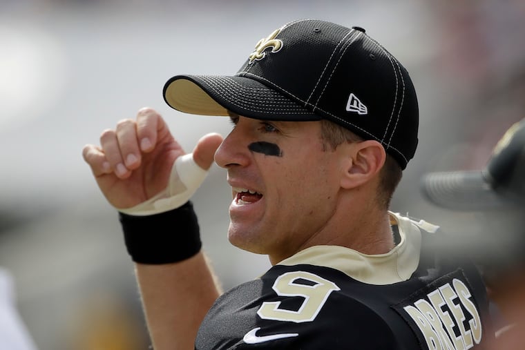 Saints quarterback Drew Brees watches from the sidelines after getting hurt during the first quarter of Sunday's loss to the Rams.