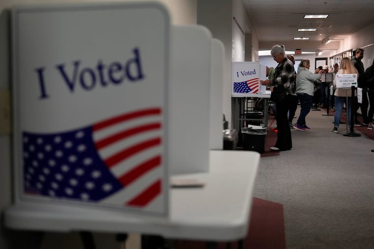 People fill out mail-in ballots for the 2024 General Election in the United States at a Voters Services satellite office at the Chester County Government Services Center, Friday, Oct. 25, 2024, in West Chester, Pa.