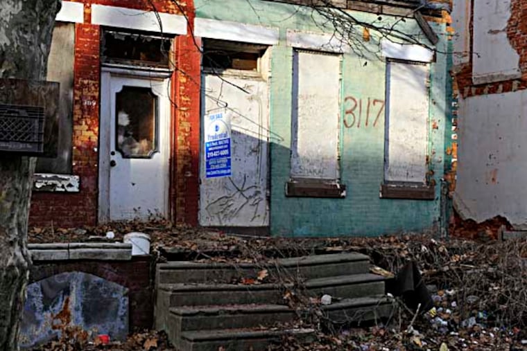 3117 Euclid Ave. (right), March 14, 2014, one of 585 properties on L&I’s “imminently dangerous” list. They are a mix of private- and publicly-owned buildings that are in such disrepair that the only way to render them safe is to completely knock them down. ( TOM GRALISH / Staff Photographer )