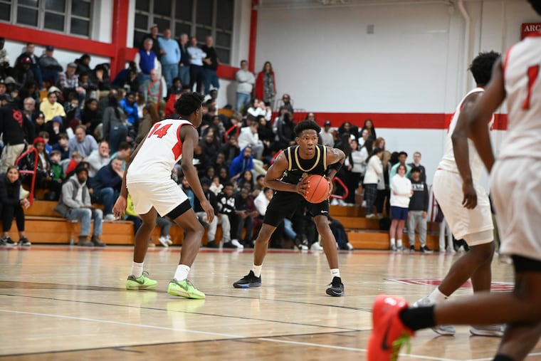 Neumann Goretti’s Larenzo Jerkins looks to pass against Archbishop Carroll on Jan. 2 at Carroll.