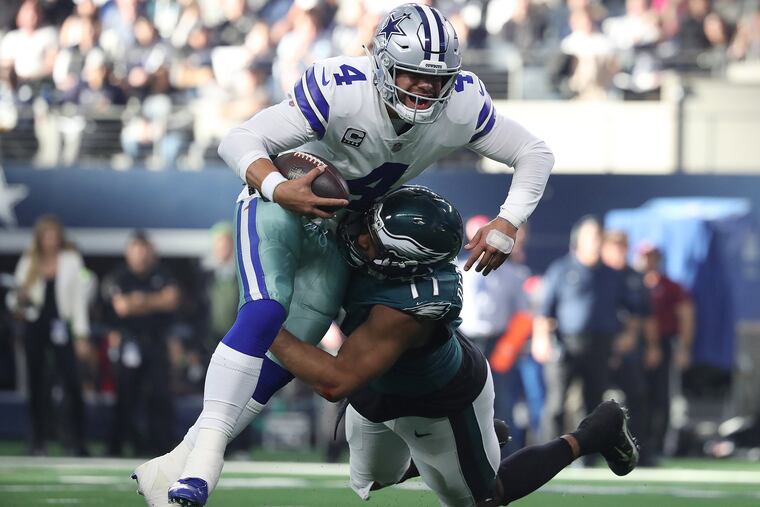 Eagles defensive end Michael Bennett, right, stops Dallas quarterback Dak Prescott for a loss in the first quarter.